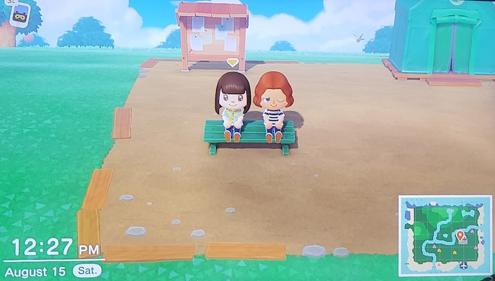 My nieces sitting on a bench in Animal Crossing