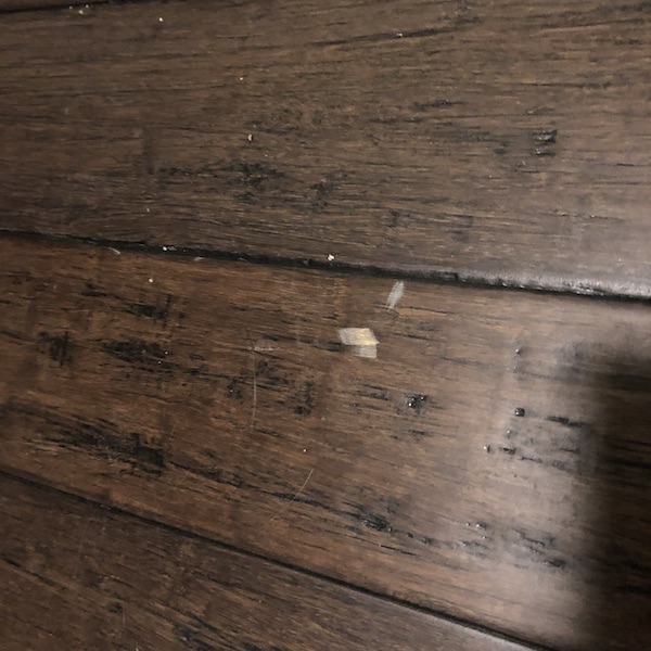 Wide gouge on entryway floor.