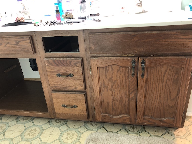 The old dark wood cabinet without the doors & the old floor.