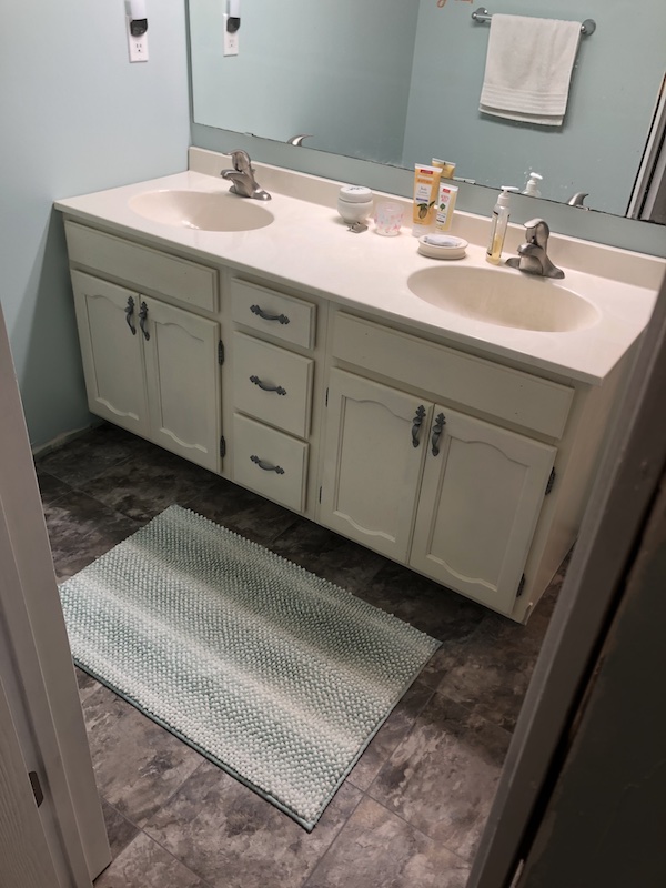 white vanity with grey floor