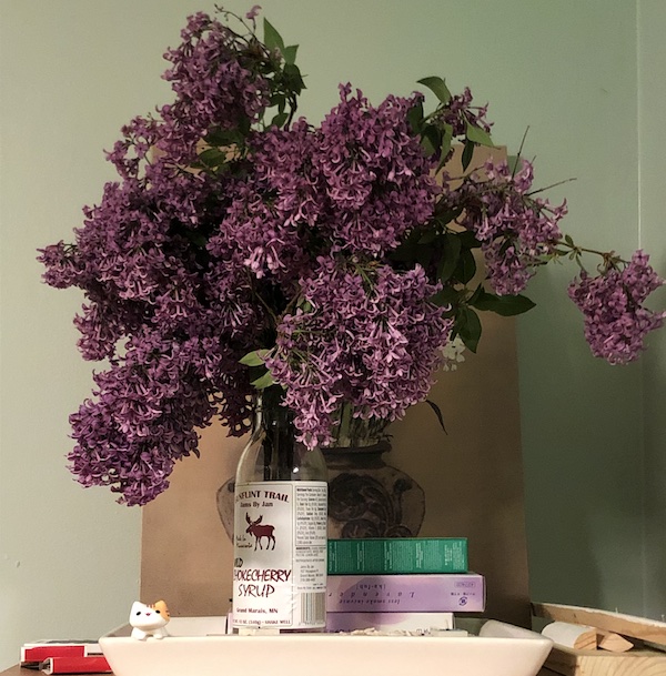 a makeshift vase of lilacs